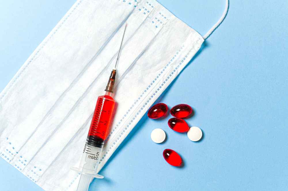 syringe and pills on blue background
